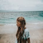 A profile photo of Sara walking on a beach