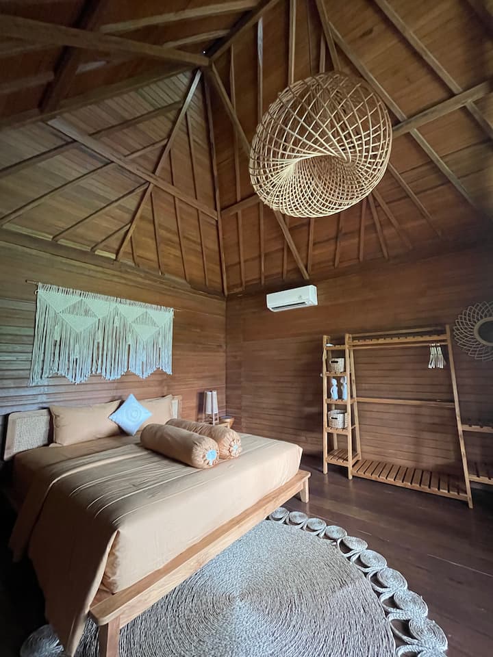 The rooms at Tala Bungalows with a large bed and wooden bungalow